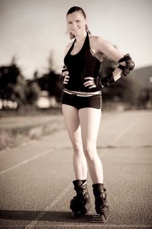 cute teenage girl posing on rollerblades