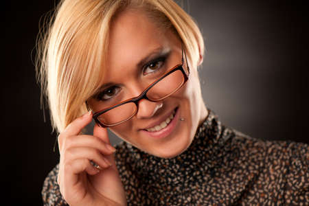Beautiful young blonde with eyeglasses isolated の写真素材