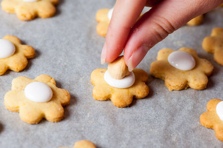 A woman maikng sweet cookies in kitchen