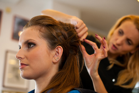 Young woman in hairdresser saloon having a haircutの写真素材