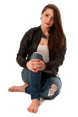 attractive young woman sitting isolated over white backgroundの写真素材