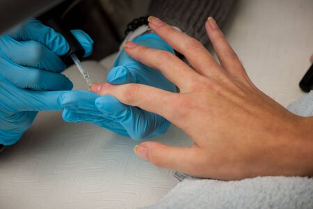 Making hand nails in a professional hand care salon