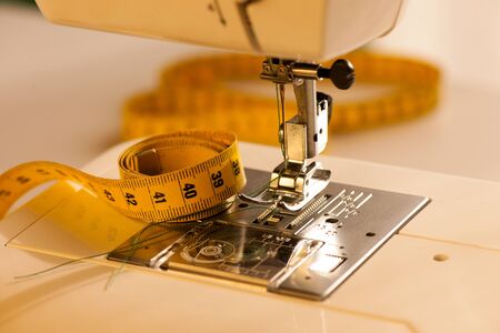 Background with sewing tools meter and machineの写真素材