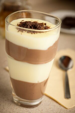 Mixed chocolate and vanilla pudding served in a glass decoratedの写真素材