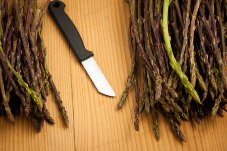 Fresh wild asparagus on a plate with eggs  ready to be cookedの写真素材