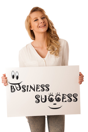 Beautiful young caucasian woman holding a blank white board in her hand isolaetd over white backgroundの写真素材