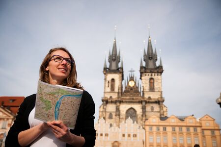 Beautiful young tourist woman photographing sites in Prague Czech republicの写真素材