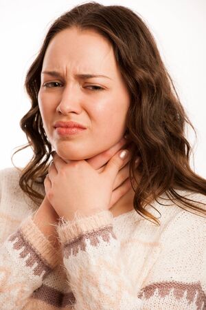 Asian caucasian woman with flu suffering a sore throatの写真素材