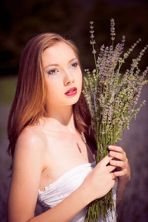 Beautiful young woman on lavender fieldの写真素材
