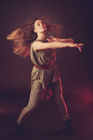 Young brunette caucasian woman dancing and her hair flowing through the airの写真素材
