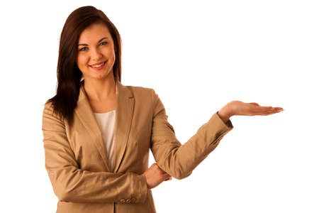 Beautiful young business woman pointing into copy space isolated over white backgroundの写真素材