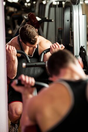 Handsom young man workout in fitness gymの写真素材