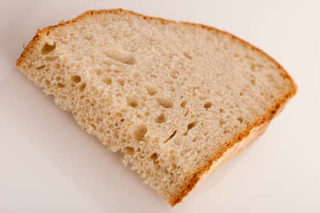 Slice of fresh baked bread made of cereal flouer isolated over white background.