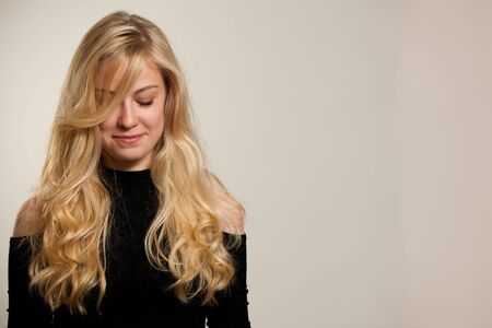 Beautiful young woman with gorgeous hairstyle posing  over white