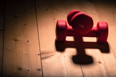 dumbbells on a wooden flor in gymの写真素材