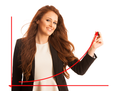Young businesswoman writing on transparent board against white background. Horizontal shot.の写真素材