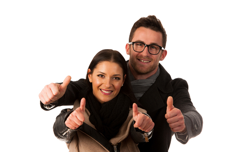 Business couple celebrating success holding fists and screaming of joy. Team work conceptual image.の写真素材