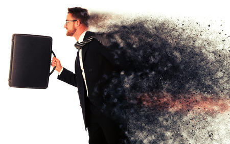 Successful businessman in formal suit and briefcase, running being late isolated over white.の写真素材