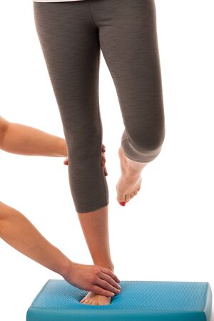 Physiotherapy - therapist doing   excercises for improving coordination and stability with a patient to recover  after injuryの写真素材