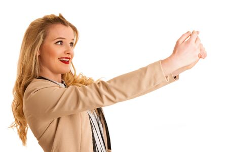 Beautiful young woman taking selgfie photo with smartphone isolatedの写真素材