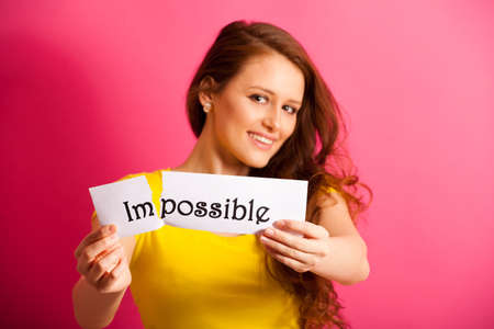 woman tearing appart paper with textの写真素材