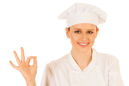 Beautiful young chef woman gestures excelent isolated over white backgroundの写真素材
