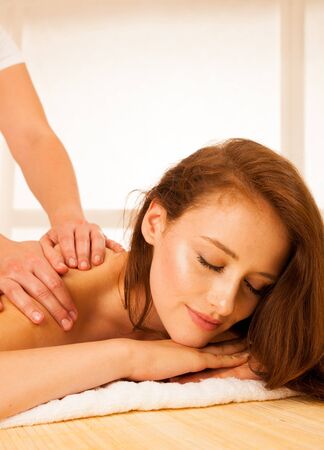 Body care. Spa body massage treatment. Woman having massage in the spa salonの写真素材