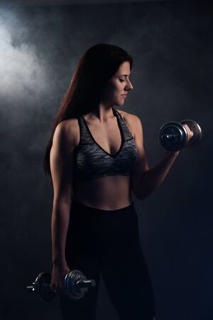 Active young woman workout with dumbbellsの写真素材