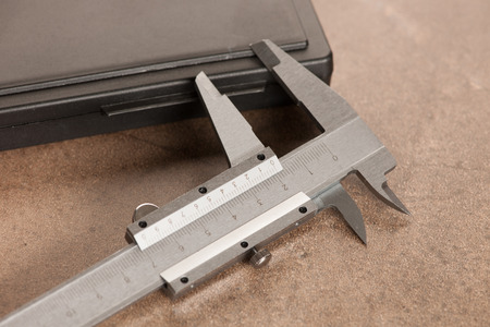 Image of iron calipers close-up on stone desk  backgroundの写真素材