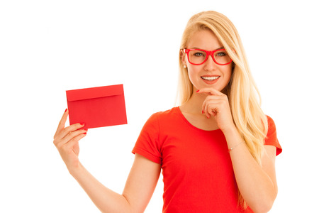 Beautiful young woman holds red envelope  - a love letter for valentines dayの写真素材