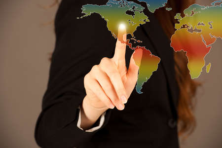 Attractive business woman pressing a virtual buttonの写真素材