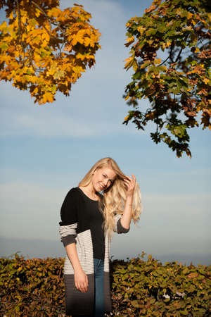 outdoor portrait of beautiful blond woman in autumnの写真素材