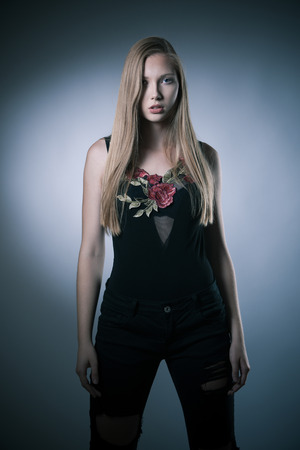 Moody studio portrait of a beautiful young brunette woman with long hairの写真素材