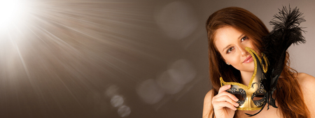 atractive young woman with venice mask studio portraitの写真素材