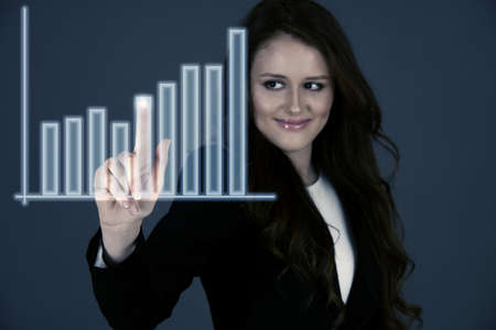 Attractive business woman pressing a virtual buttonの写真素材
