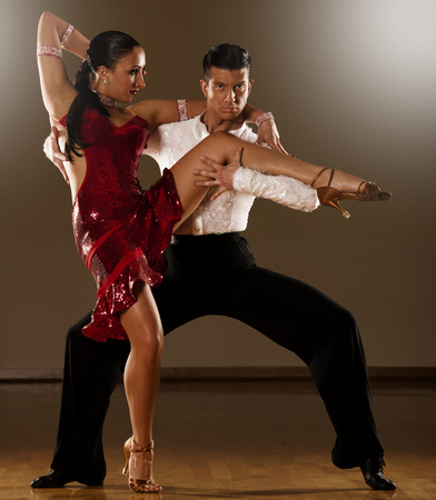 latino dance couple in action - dancing wild sambaの写真素材