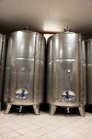 Modern wine factory with new large tanks for the fermentation. modern wine cellar with stainless steel tanks.の写真素材