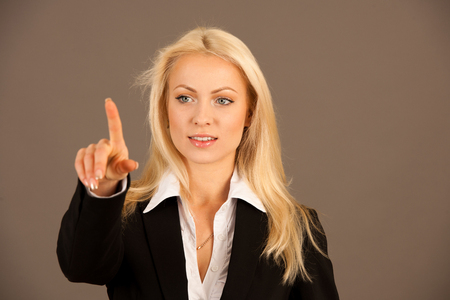 Beautiful busienss woman browsing web on her tabletの写真素材