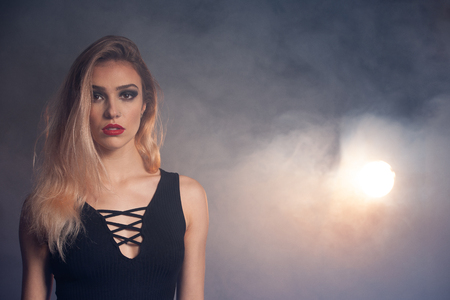 Beauty portrait of a beautiful young caucasian woman over smoky backgroundの写真素材