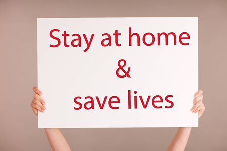 White board - with text stay at home and save lives a call to prevent spreading covid-19 corona virus pandemicの写真素材