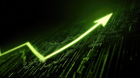 Green arrow pointing upward on financial chart representing successful business growthの素材