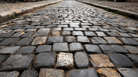 Old cobblestone street with irregular stone patterns and weathered surface textureの素材