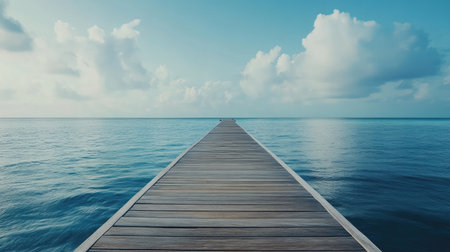View of wooden jetty extending over the sea connecting to distant overwater villas in Maldivesの素材