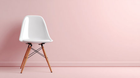 A stylish white chair stands elegantly against a soft pink wall, showcasing minimalist design and perfect for contemporary interior decor ideas.の素材