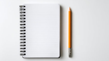 A blank spiral notebook positioned next to an orange pencil on a clean white background. Ideal for capturing ideas, sketches, or notes in various creative projects.の素材