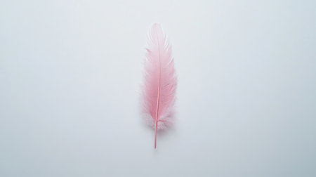A delicate pink feather rests gracefully on a smooth, minimalist background, showcasing its soft texture and elegant form. Ideal for artistic and design projects.の素材