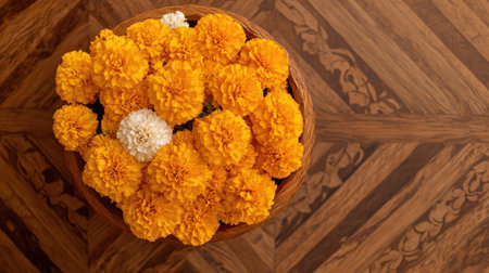 A vibrant arrangement of bright marigold flowers in a rustic wooden bowl, showcasing stunning yellow and orange hues against a detailed wooden surface.の素材