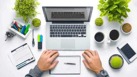 An organized workspace featuring a laptop, notebooks, and office supplies. Ideal for conveying productivity, creativity, and a modern work environment.の素材