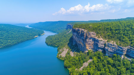 A stunning aerial view showcasing cliffs overlooking a tranquil river, surrounded by lush greenery and a clear blue sky, perfect for nature enthusiasts.の素材
