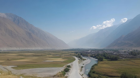 Explore a breathtaking valley landscape embraced by majestic mountains, featuring a winding river and lush green fields, perfect for nature enthusiasts.の素材